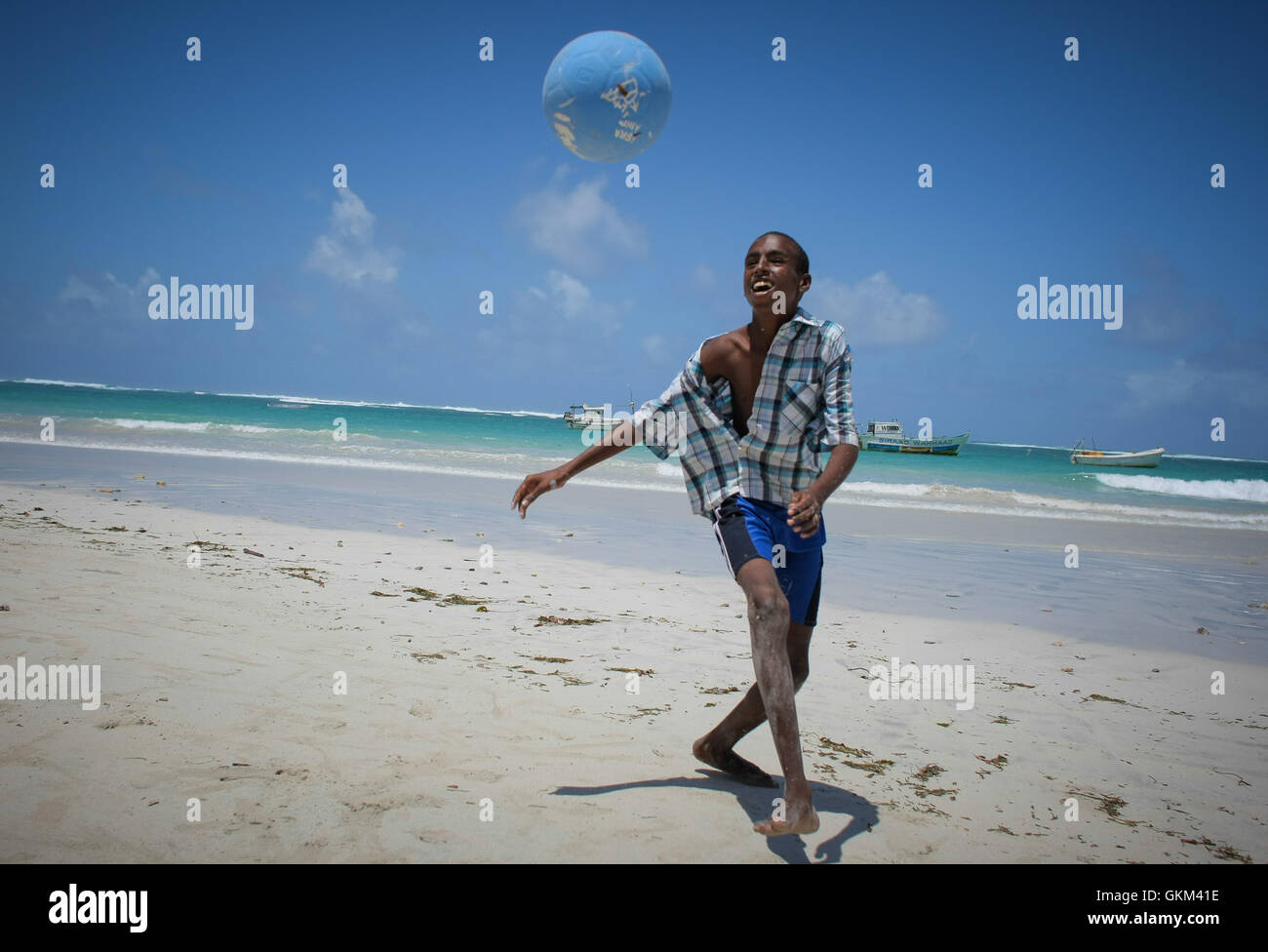 A Somali boy plays football on Lido Beach in Mogadishu, Kaaraan ...