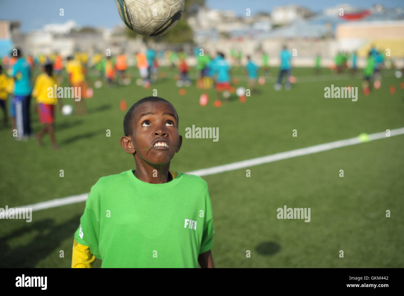A child headers a ball during practice at the FIFA Football Festival in Mogadishu, Somalia, on August 19