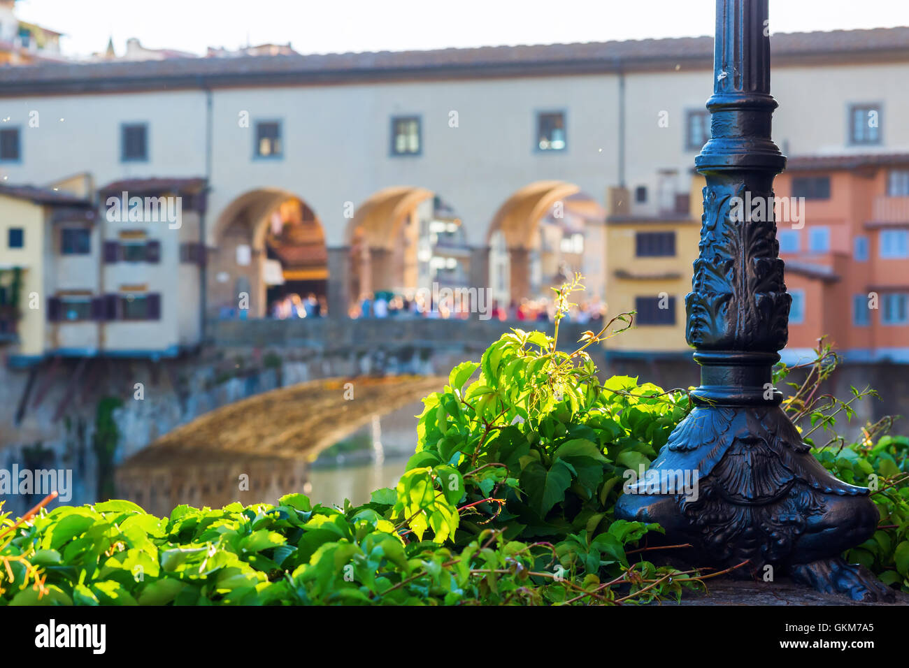 socket of an antique street lamp on a wall at the river Arno in