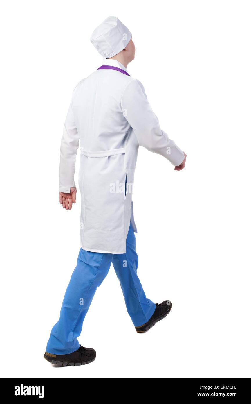 Back view of walking doctor in a robe hurrying to help the patie Stock Photo