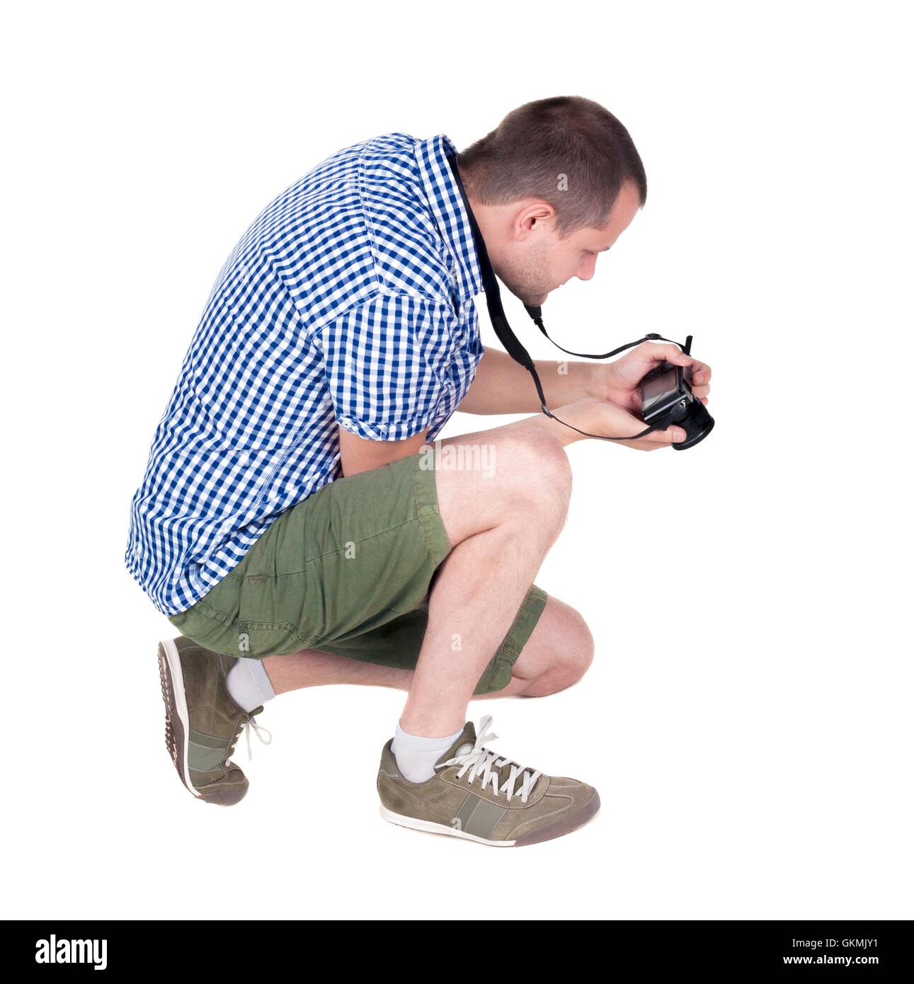 Back view of man photographing. photographer in shorts. Rear view