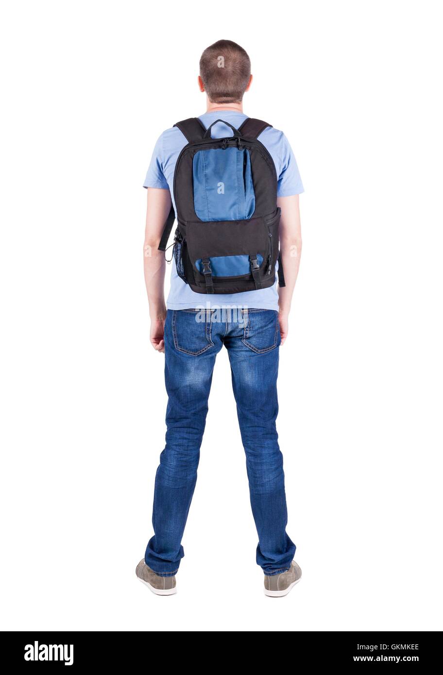 Back view of man with backpack looking up. Rear view people collection. backside view of person. Isolated over white background. guy in the green t-shirt stands with a suitcase on wheels Stock Photo