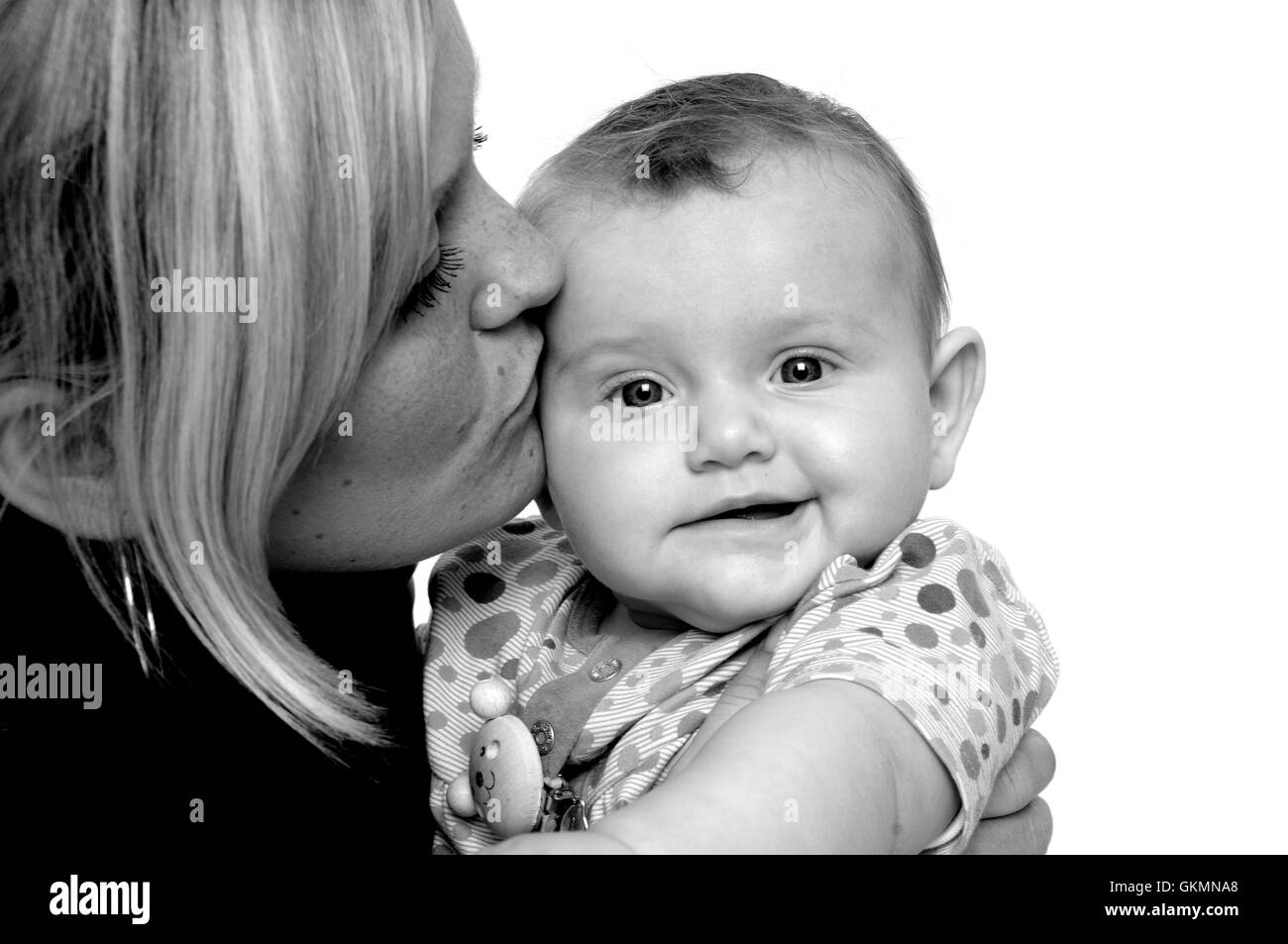 Mother is kissing baby Stock Photo - Alamy