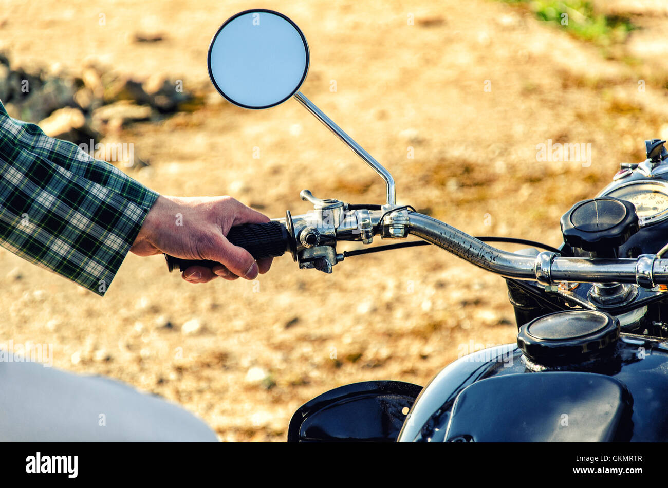 Man's hand rests on the steering wheel motorcycle Stock Photo