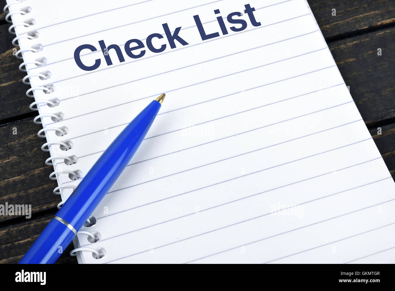 Check list text on notepad and blue pen Stock Photo - Alamy