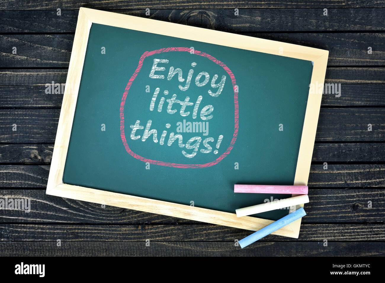Enjoy little things text on school board and chalk Stock Photo