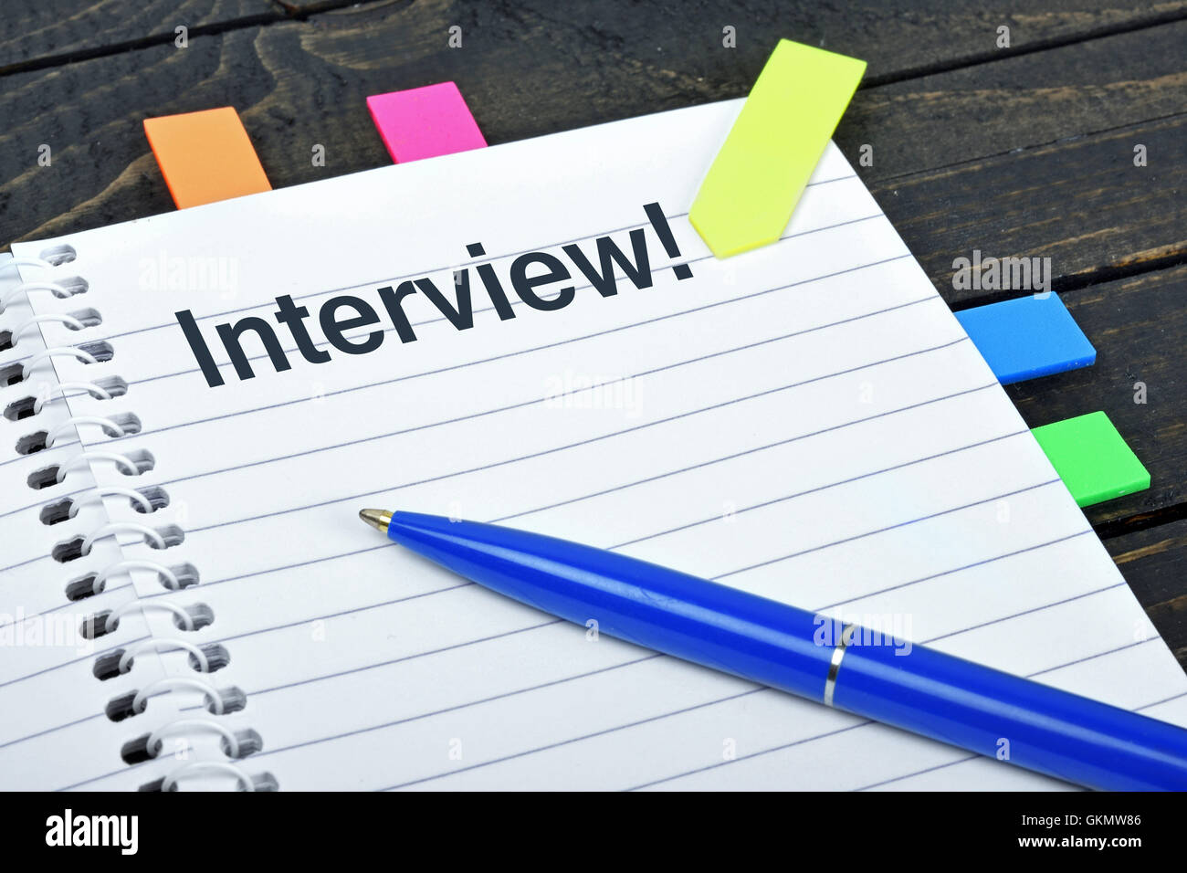 Interview word on notepad and pen Stock Photo
