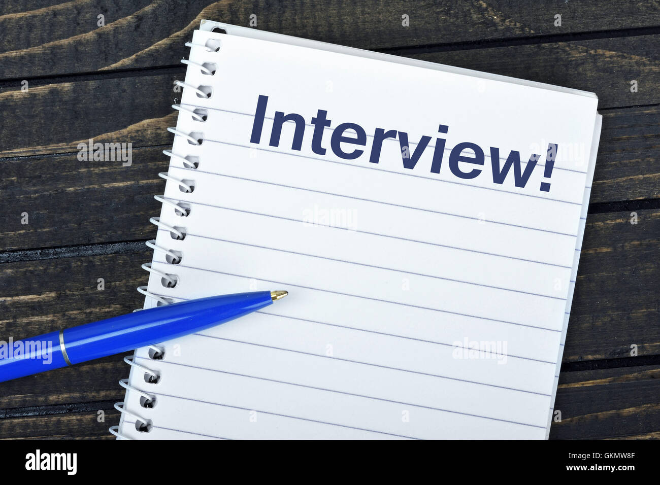 Interview text on notepad and blue pen Stock Photo
