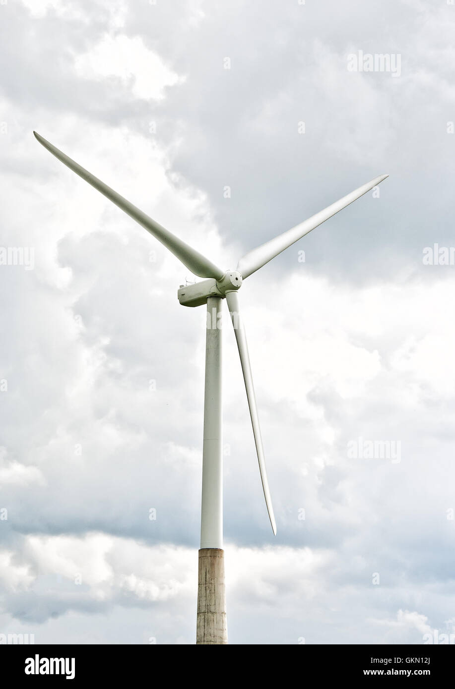 Wind turbine on a cloudy sky background Stock Photo - Alamy