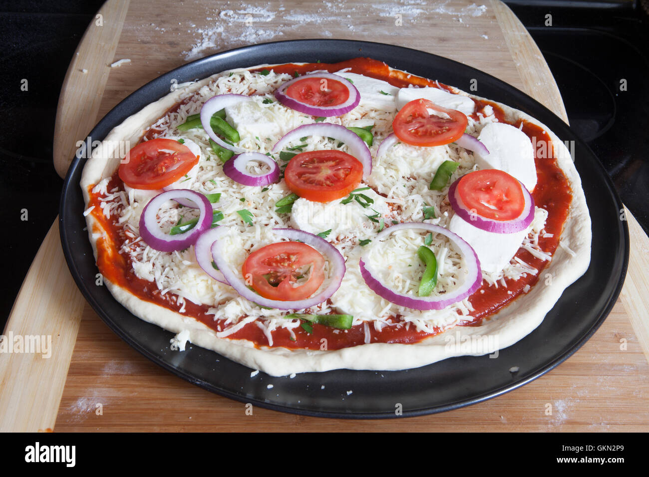 NYC, New York Style Pizza, tomatoes, fresh mozzarella, red onions,green bell, peppers stone, vegetarian pizza, Italian Pizza, Stock Photo