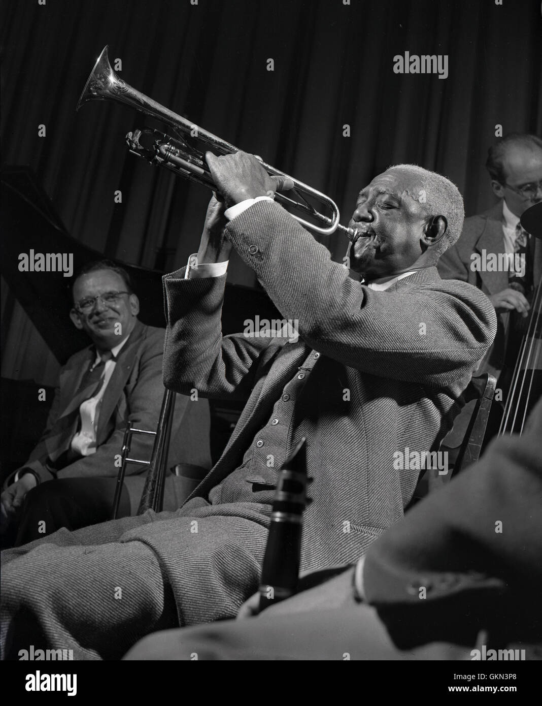 Bunk Johnson with the Doc Evans’ band. Don Thompson is on left side, and Cliff Johnson is on right on bass. Stock Photo