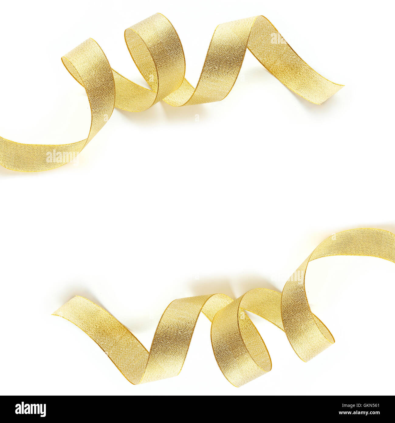 Sandy Gold Ribbon Background Shiny gold satin ribbon on white background with copy space Stock Photo ...