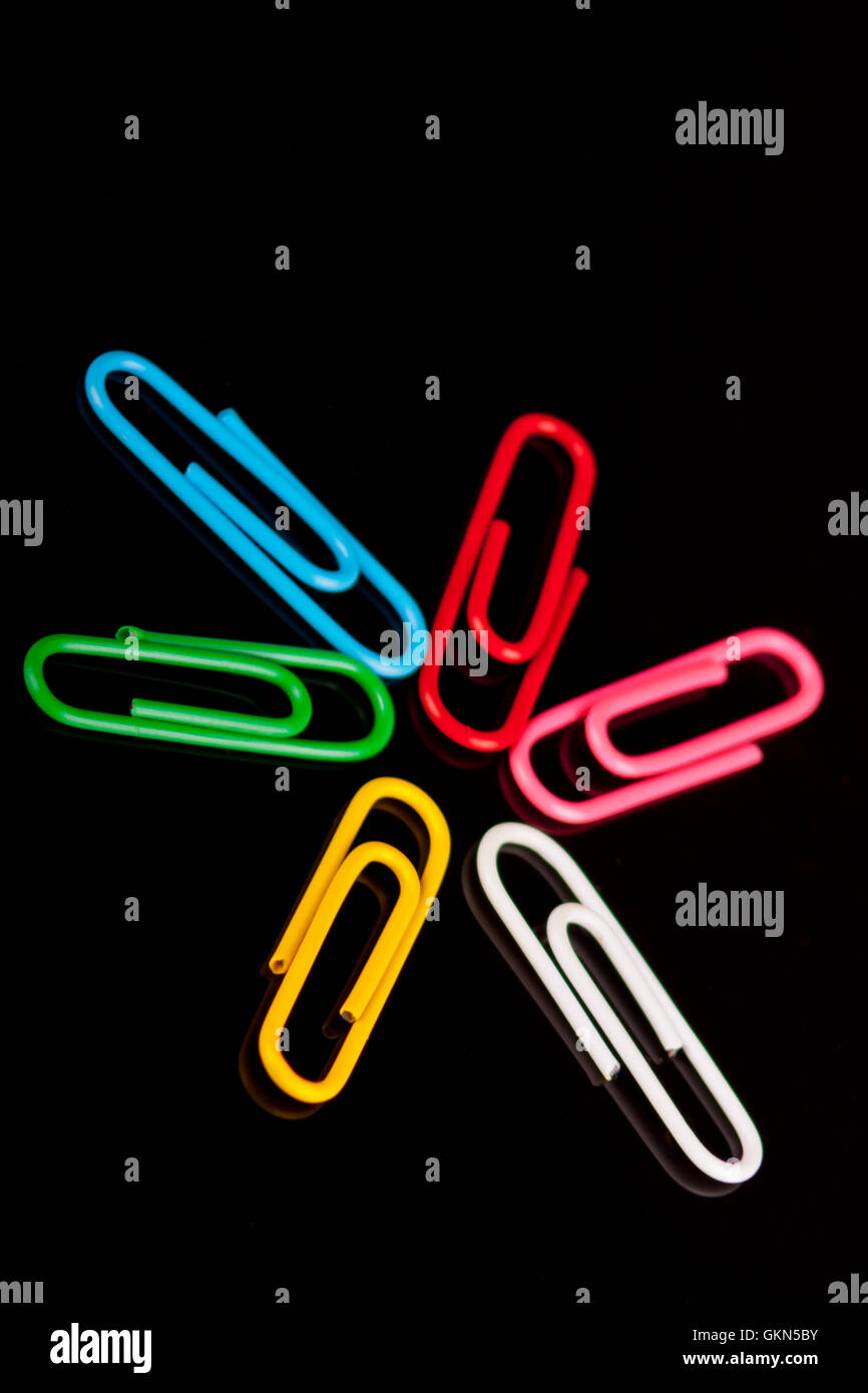 photo of colorfull paper clips on a black background Stock Photo