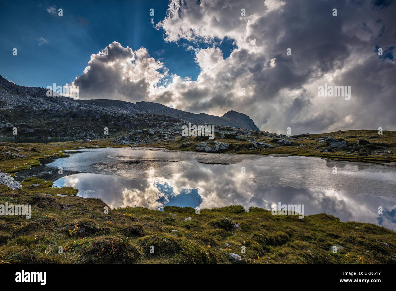 Reflections on Bombasel lake. The Lagorai mountain massif. The Fiemme Valley, Trentino. Mountain landscape. Italian Alps. Stock Photo