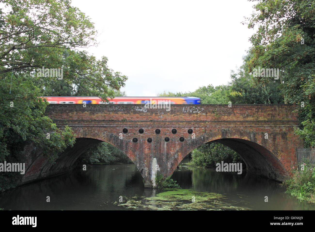 Train crossing River Mole, Hersham, Surrey, England, Great Britain, United Kingdom, Europe Stock Photo
