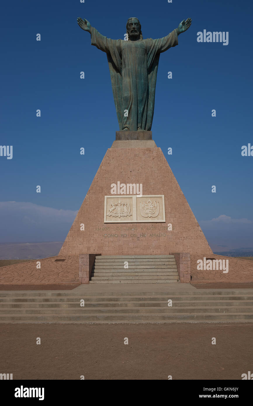 Statue of Christ on the top of the Morro de Arica, a cliff that towers above the port city of Arica in Chile. Stock Photo