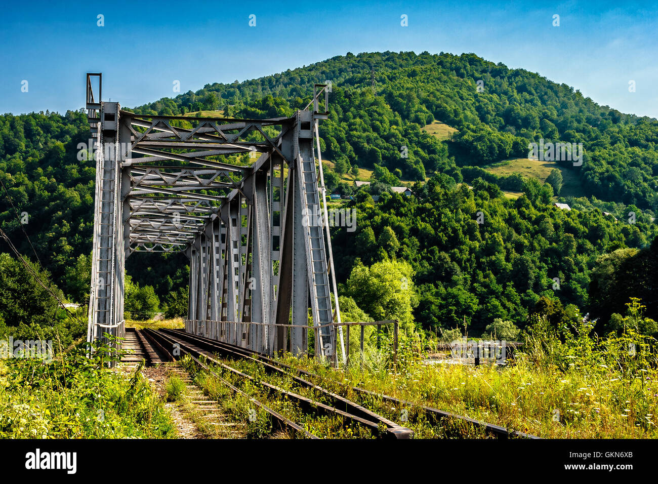 old metal rail road bridge in rural area of carpathian mountains Stock Photo