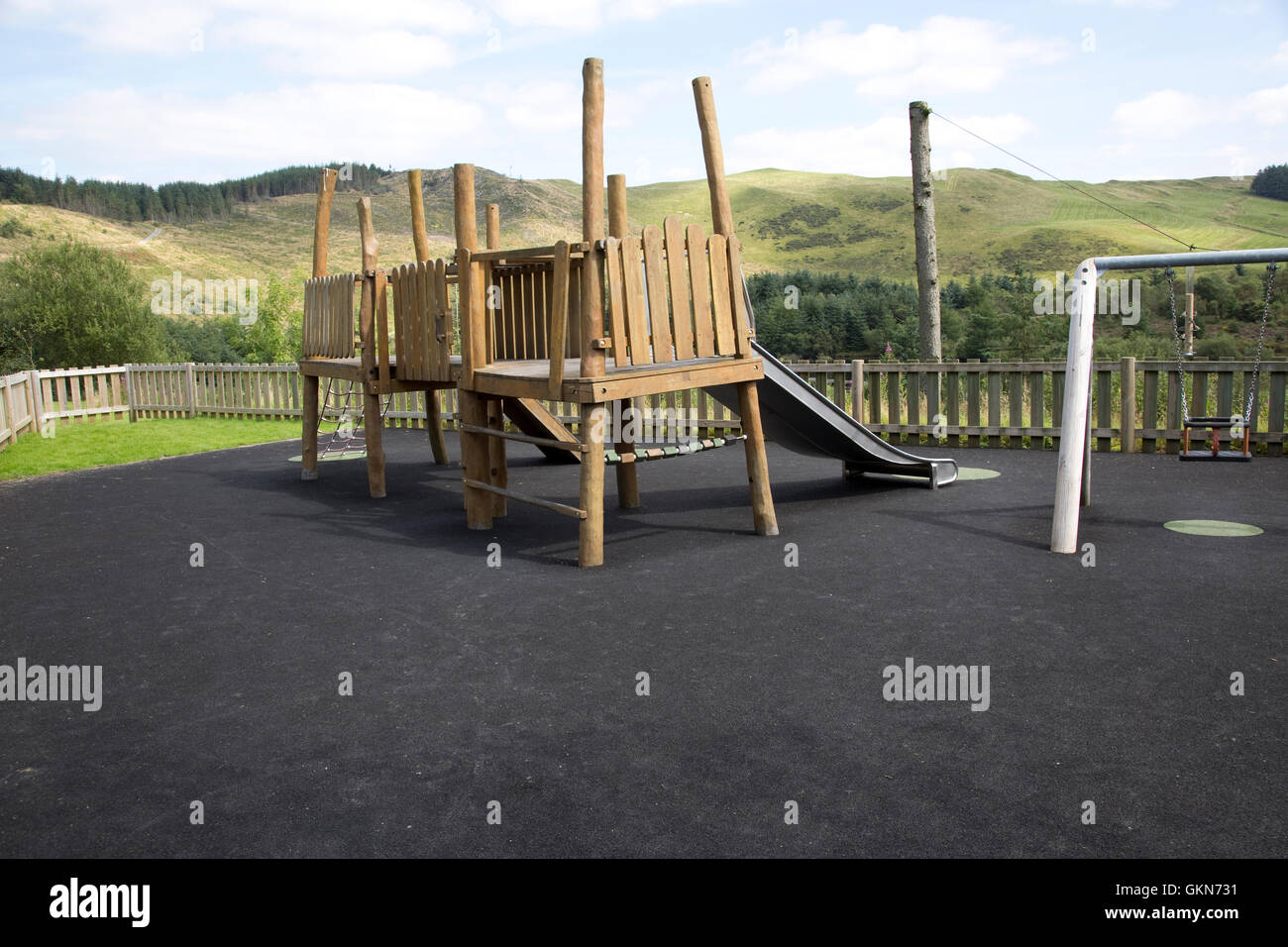 Rubber safety floor matting in outdoor rustic children's play area with