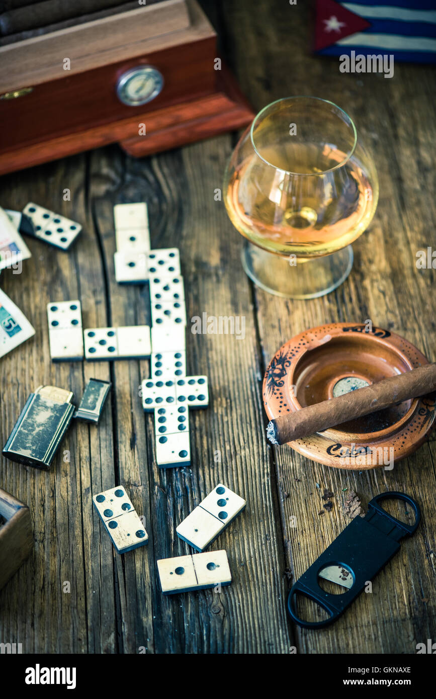 traditional cuban domino game, cigars and rum on wooden table Stock