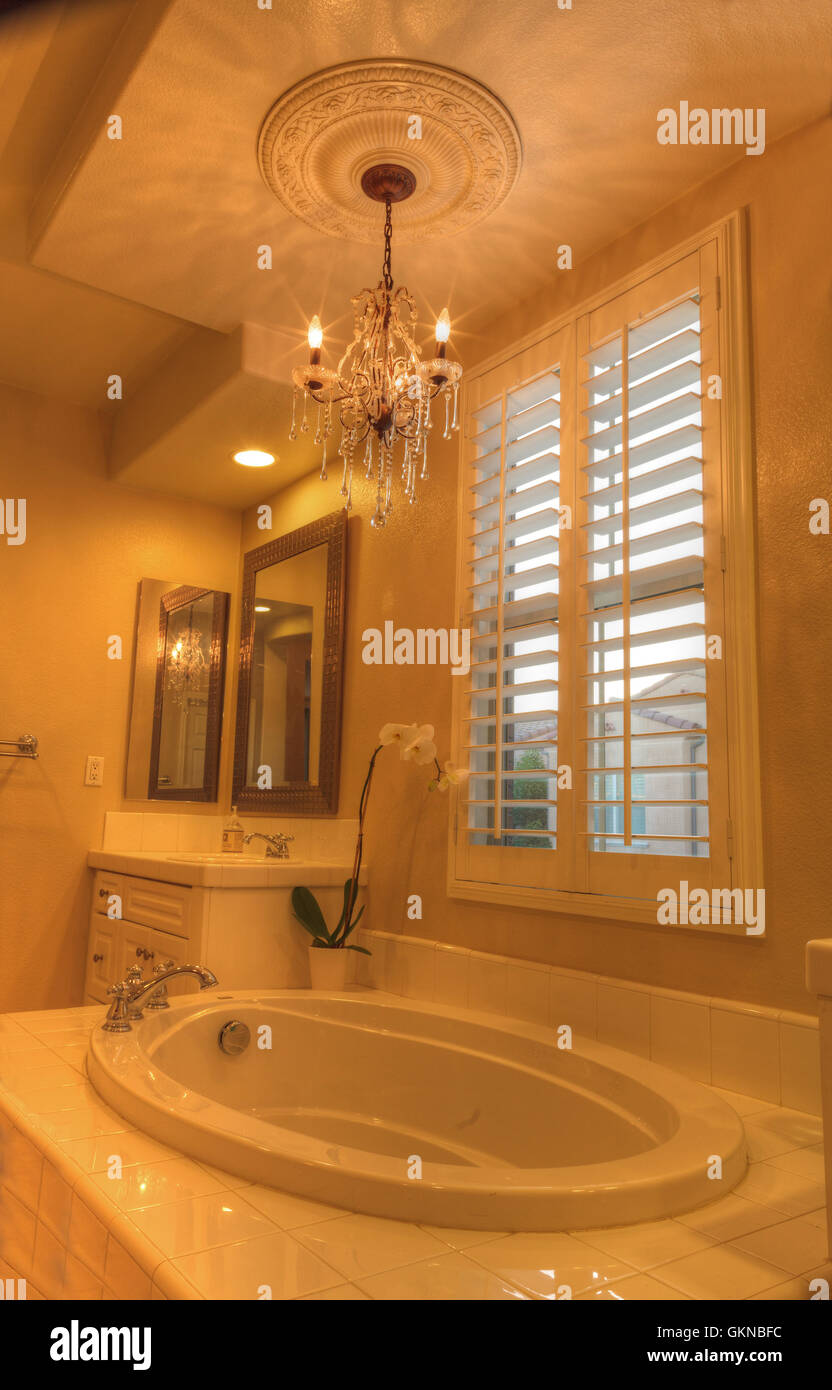 Irvine, CA, USA – August 19, 2016: Oval hot tub spa bathtub in a marble  bathroom with feng shui decor and chandelier Stock Photo - Alamy, image size:832x1390