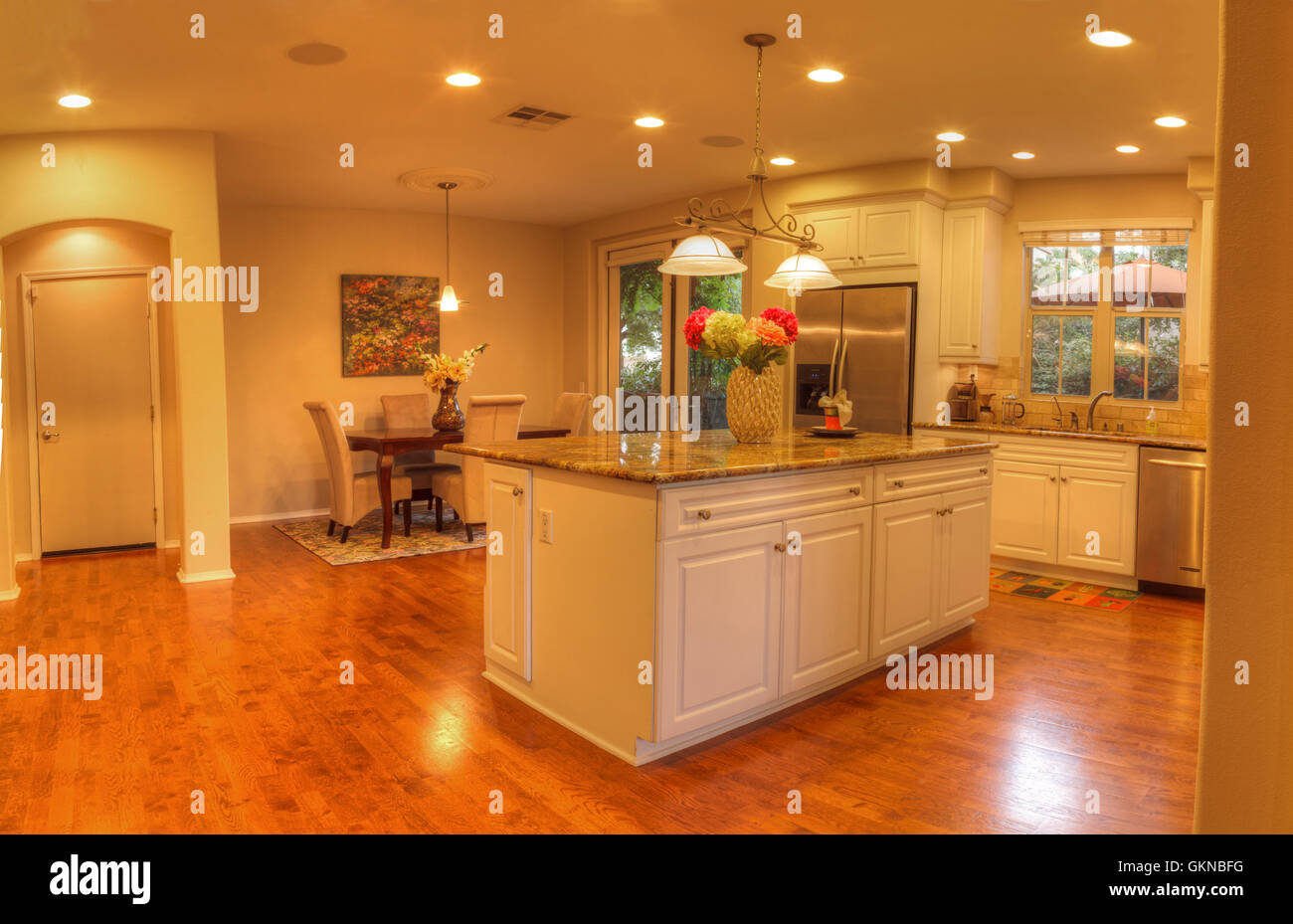 Irvine, CA, USA – August 19, 2016: Large kitchen with recessed lighting, wood floors, chrome stove, marble counter and feng shui Stock Photo