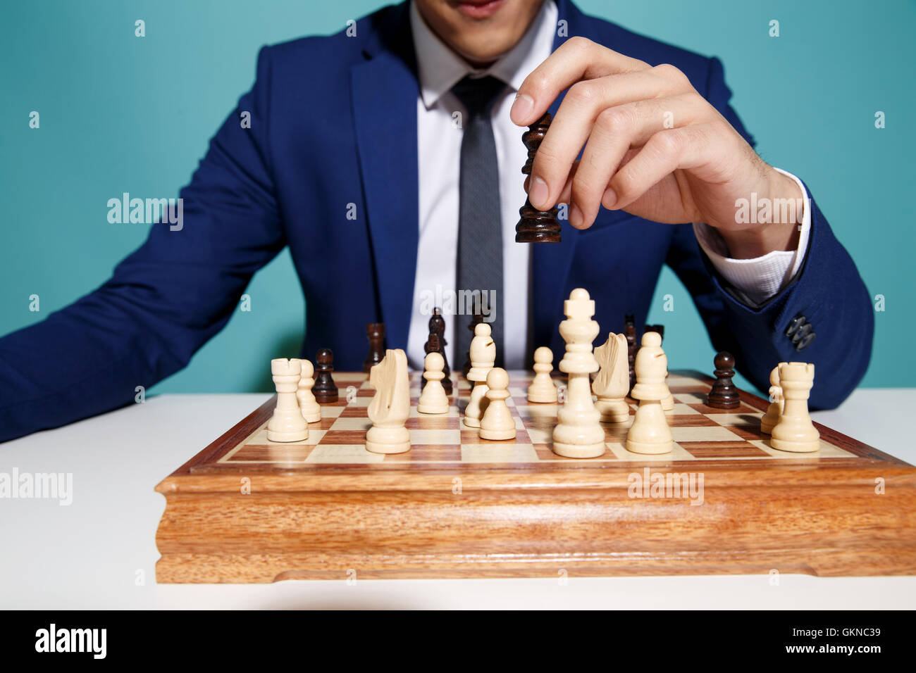 Young business man playing chess Stock Photo - Alamy