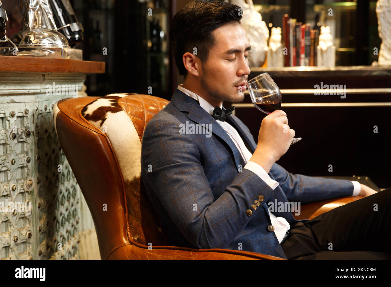 A young man with a red wine glass Stock Photo - Alamy