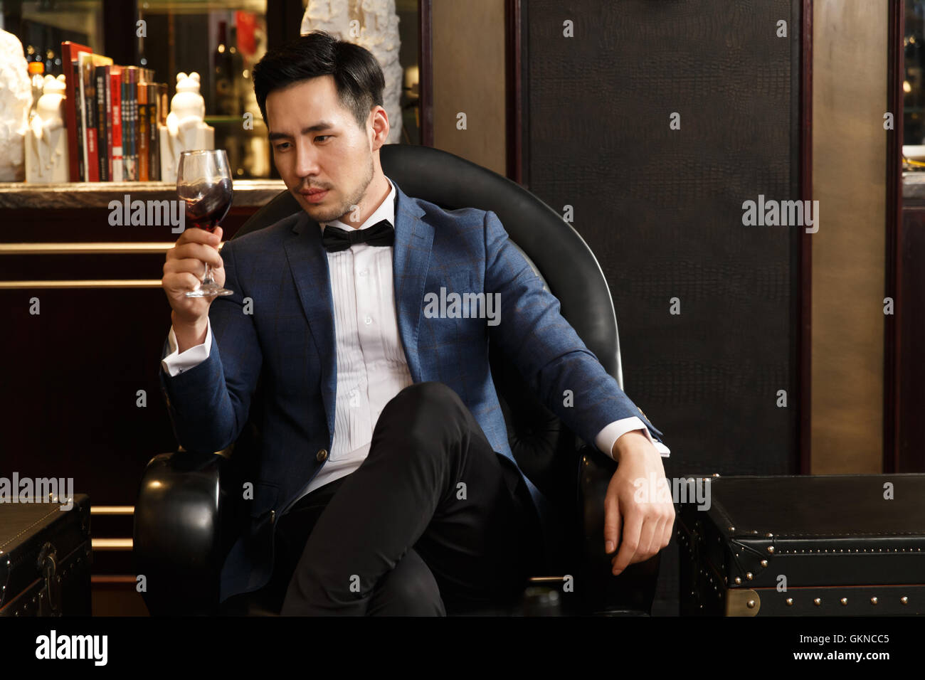 A young man with a red wine glass Stock Photo - Alamy
