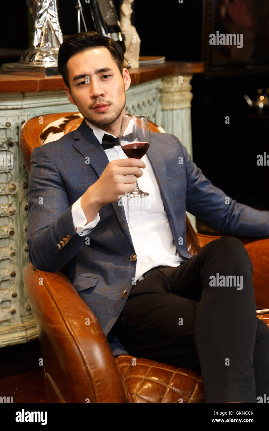 A young man with a red wine glass Stock Photo - Alamy