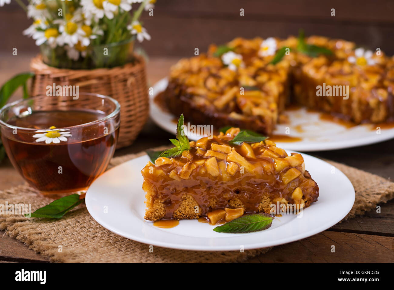 Apple pie with caramel sauce on a wooden background Stock Photo