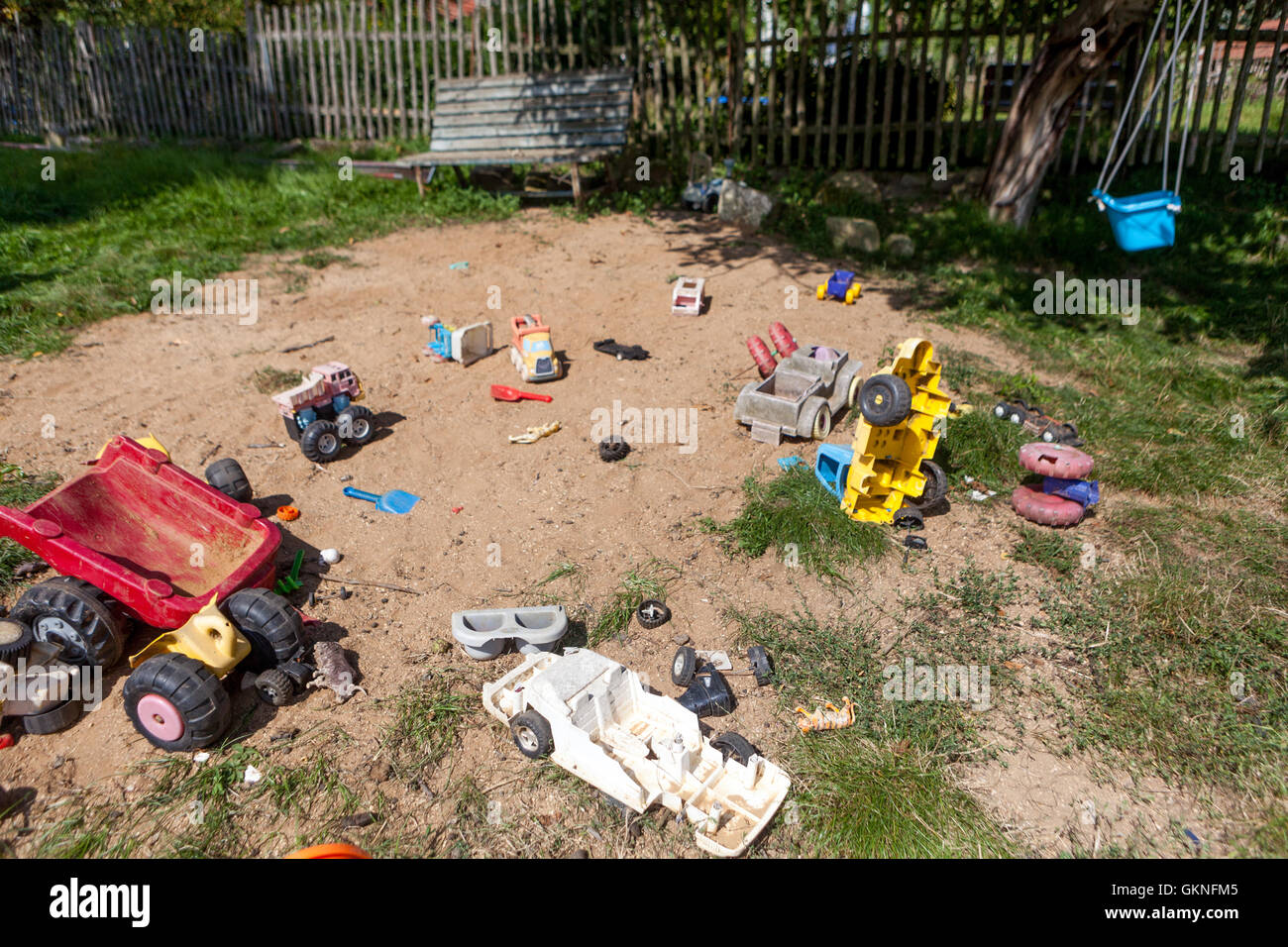 Sandpit for children playground garden with broken toys, Czech Republic Stock Photo