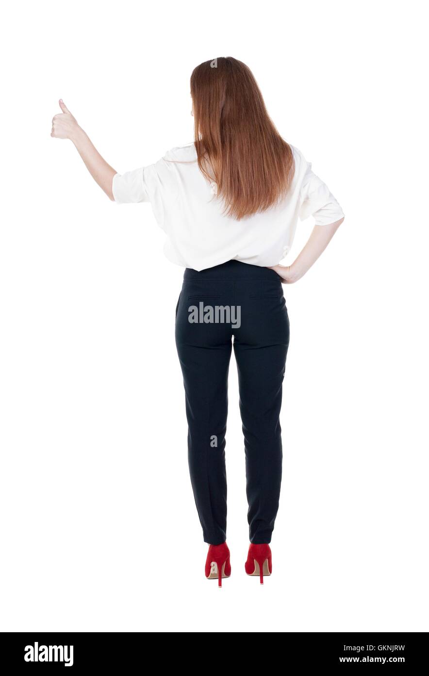 back view of standing young redhead business woman showing thumb Stock ...