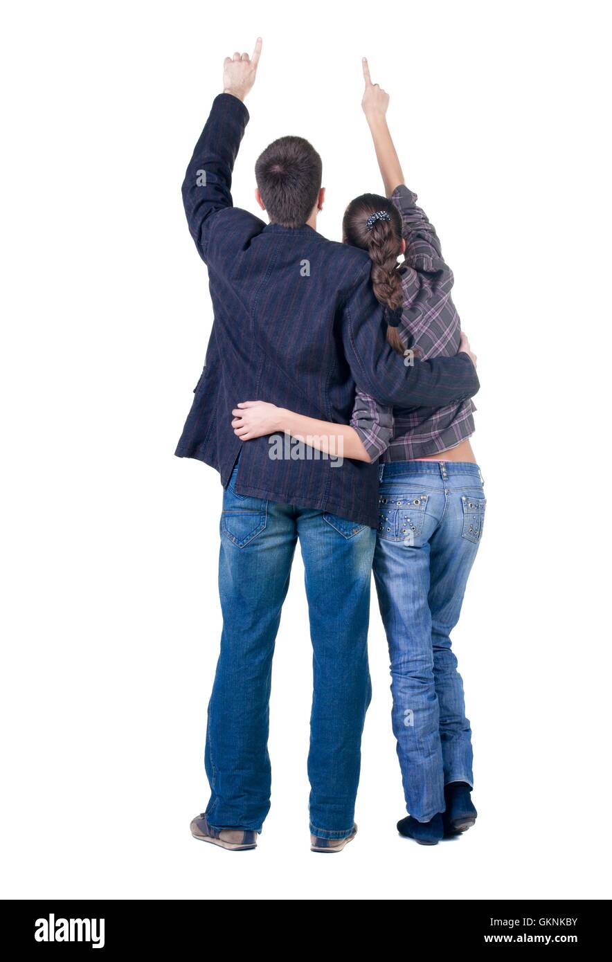 Young couple pointing at wall. Rear view Stock Photo