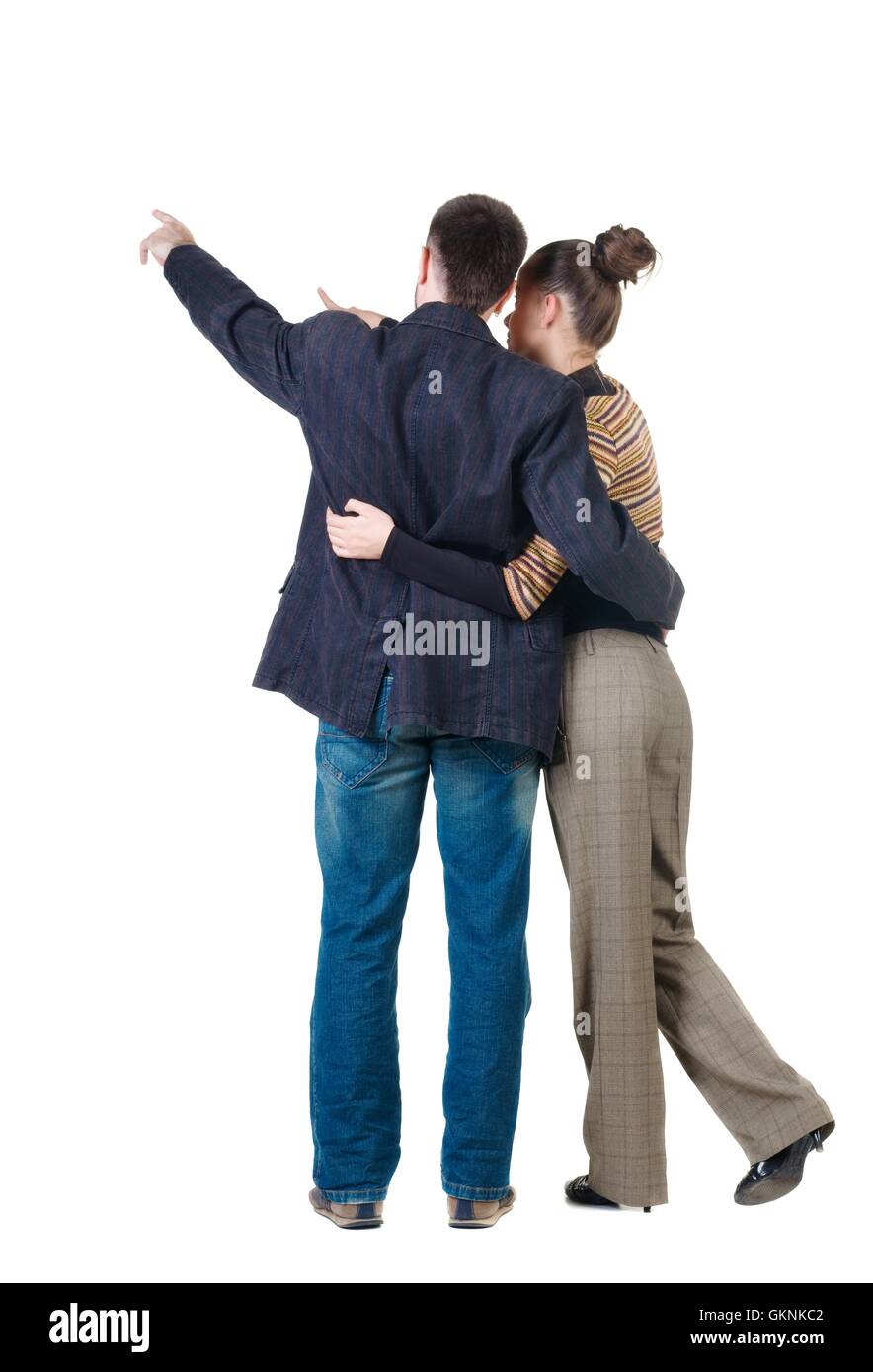 Young couple pointing at wall. Rear view. Isolated over white ba Stock Photo