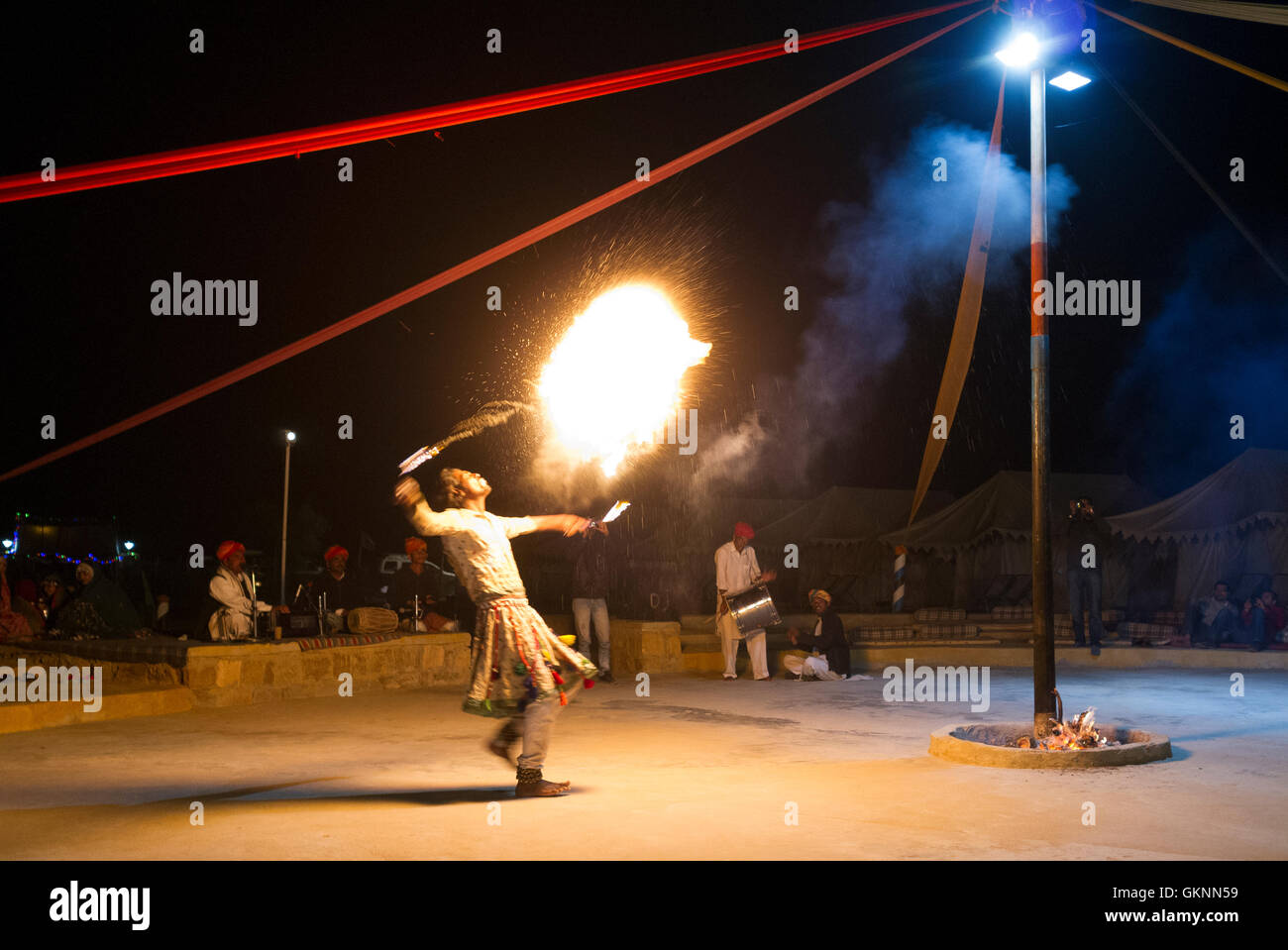 Rajasthani man dancing blowing fire Sam Sand Dunes, Jaisalmer, Rajasthan. Stock Photo