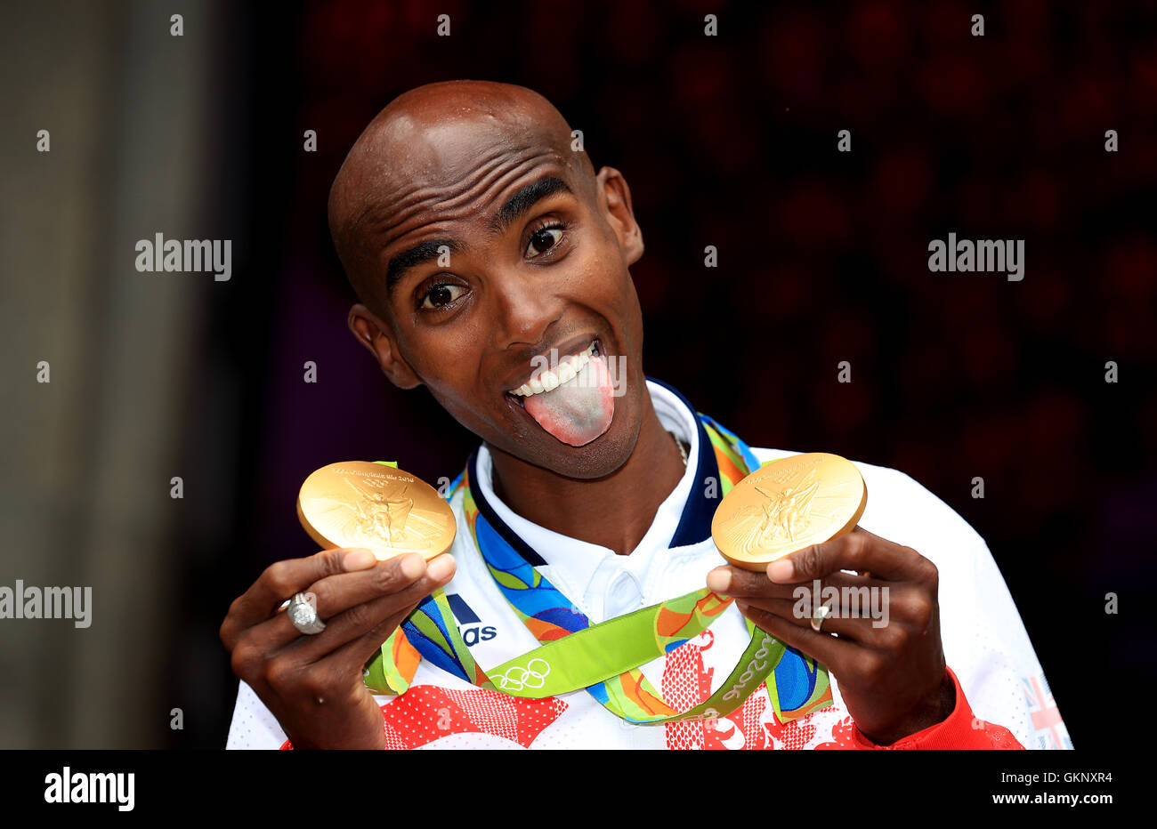 Great Britain's Mo Farah with his gold medals for victory in the Men's