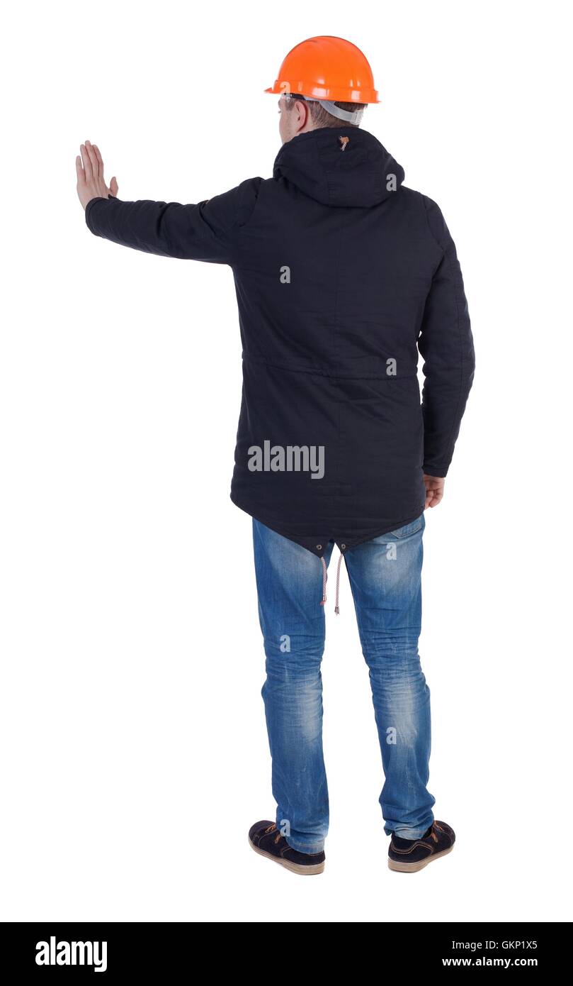 back view. Engineer in a jacket and helmet presses his hand Stock Photo ...