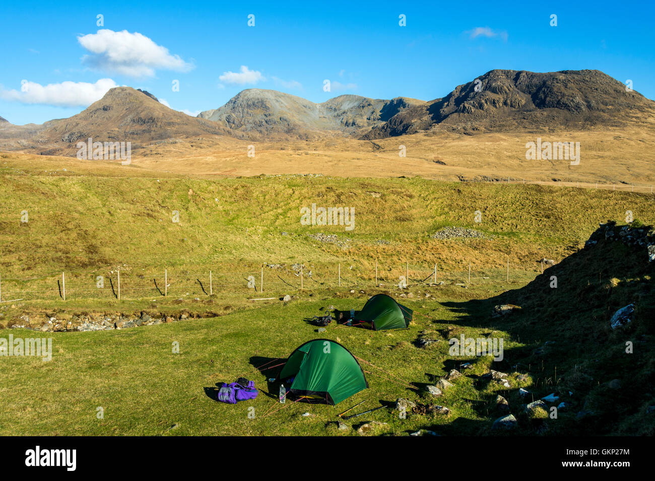 Two Hilleberg Akto solo back-packing tents at Harris Bay, Isle of Rum, Scotland, UK. The Rum Cuillin hills behind. Stock Photo