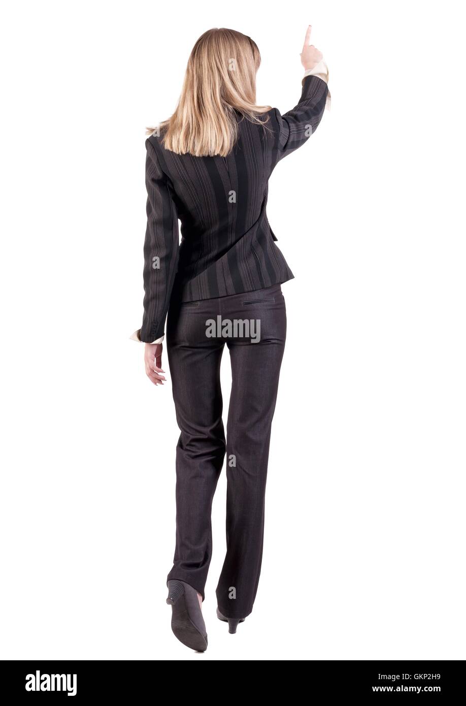 Back view of business woman walking and pointing Stock Photo - Alamy