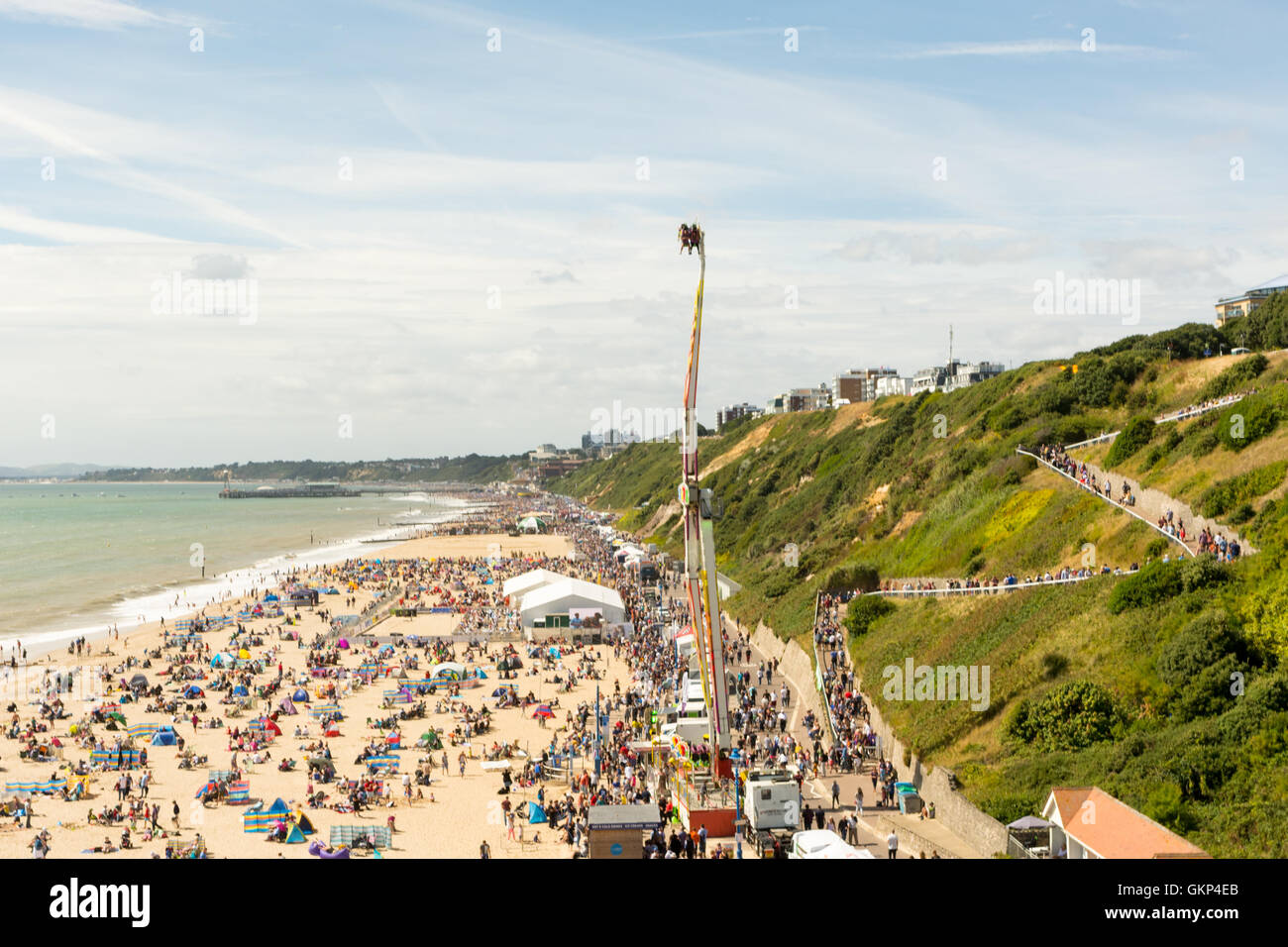Bournemouth, UK. 21st August, 2016. Fairground ride and crowds on the