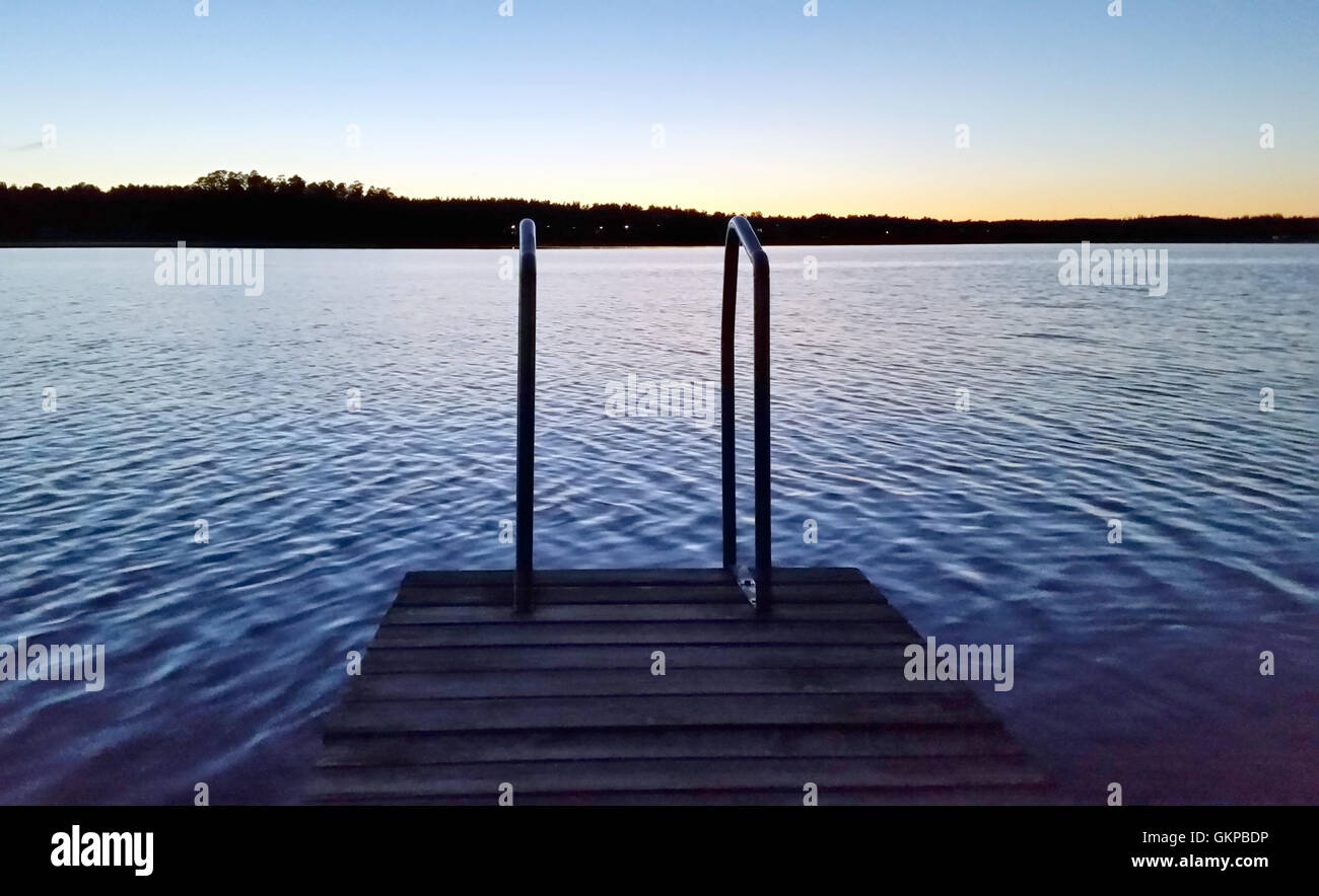 Unnaryd, Sweden. 12th Aug, 2016. A jetty with a ladder can be seen at sunset on Lake Unnen near Unnaryd, Sweden, as seen on 12 August 2016. Photo: Johannes Hennemuth/dpa -NO WIRE SERVICE-/dpa/Alamy Live News Stock Photo
