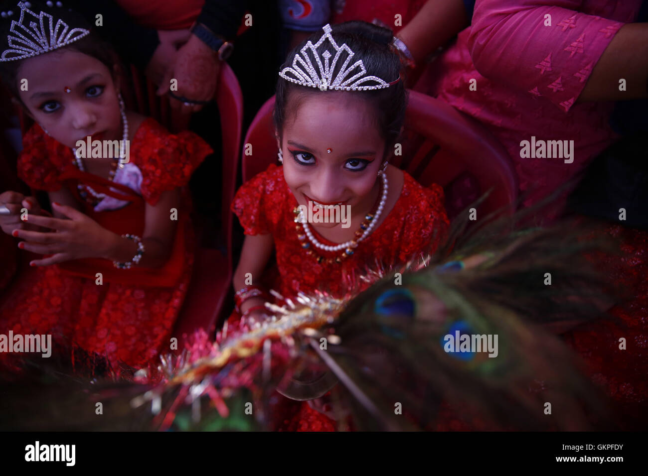 August 23, 2016 - Lalitpur, Nepal - A Nepalese girl whom are considered holy looks on while taking part in a procession to celebrate the festival of Deity Narsingh in Patan, Lalitpur, Nepal on Tuesday, August 23, 2016. Nepalese people from all over Patan of Newar community gather to offer worship by placing flowers and money to divinities as a belief to receive blessings and wellbeing of ones family. The ritual dates back to some 400 years. (Credit Image: © Skanda Gautam via ZUMA Wire) Stock Photo