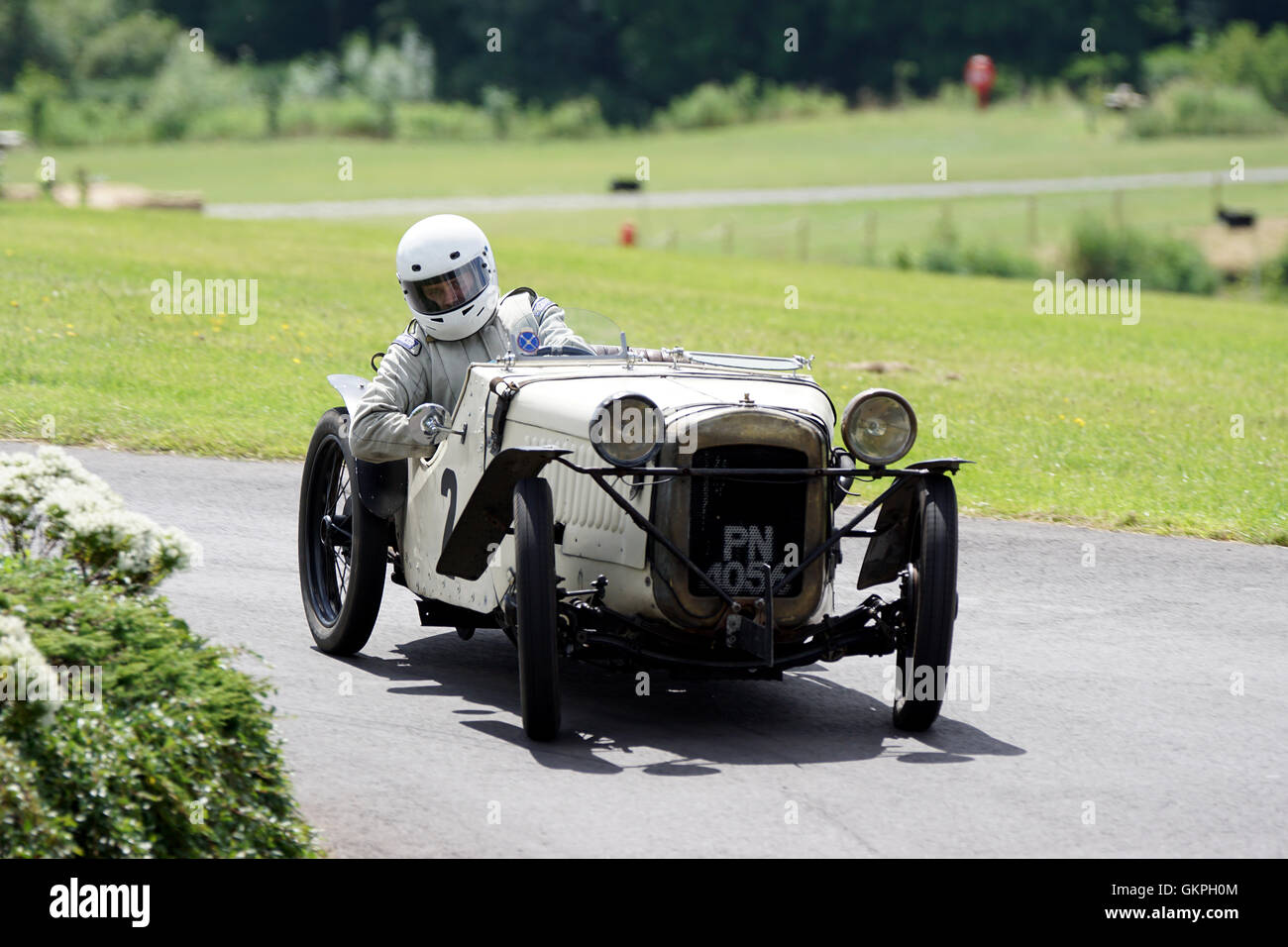 William Way throws his 1929 Austin 7 Ulster into the roundabout at the 2016 Chateau Impney Hill Climb Stock Photo