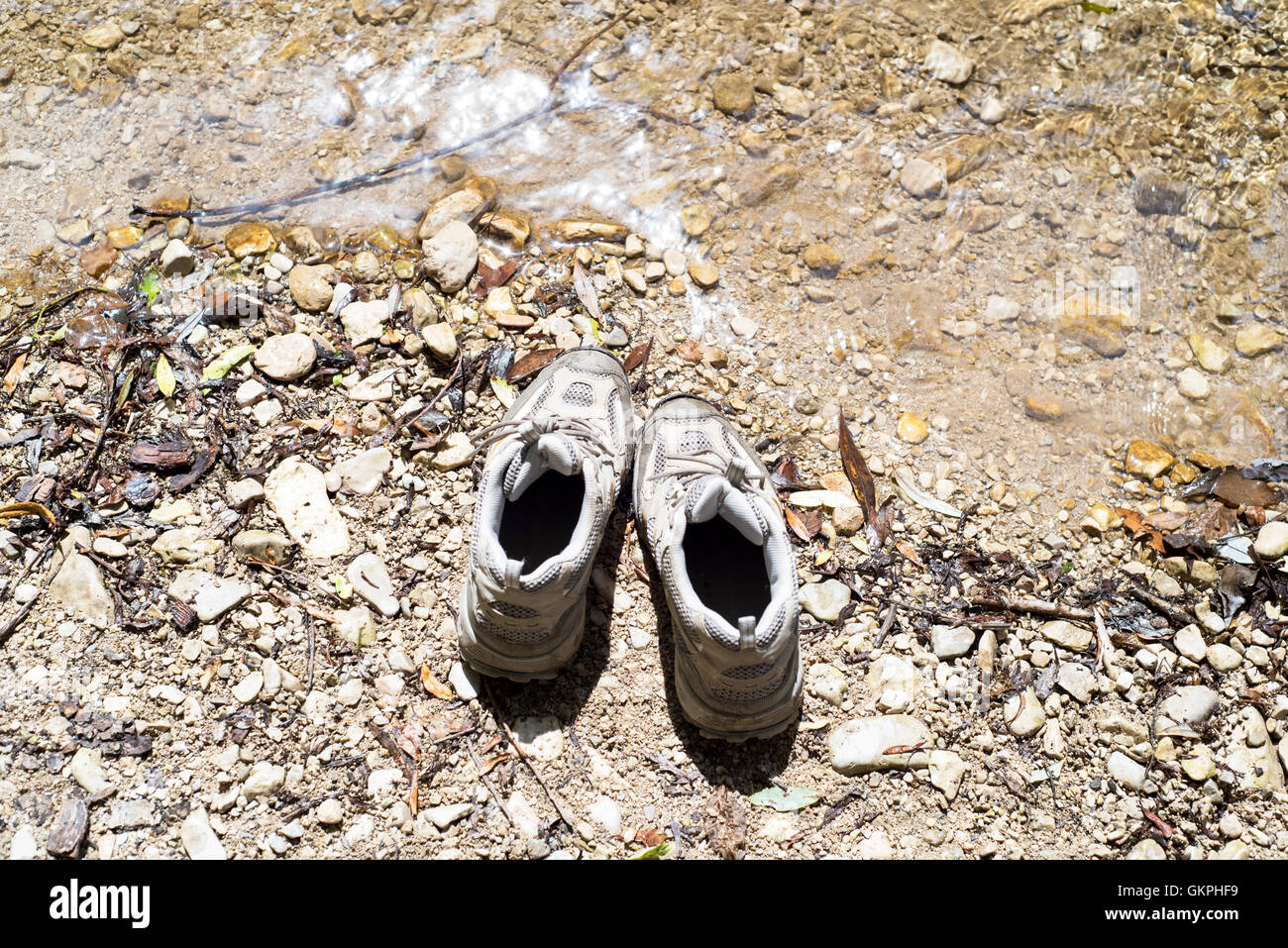 Shoes mountain on river, trekking Stock Photo