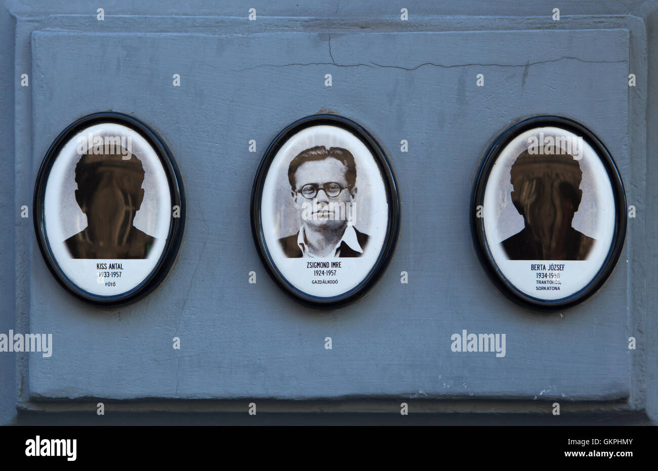 Portraits of the victims of the communist regime outside the House of Terror Budapest, Hungary. Farmer Imre Zsigmond (1924-1957) is pictured at the middle while heater Antal Kiss (1933-1957), and soldier and truck driver Jozsef Berta (1934-1958) have no photographs. Stock Photo