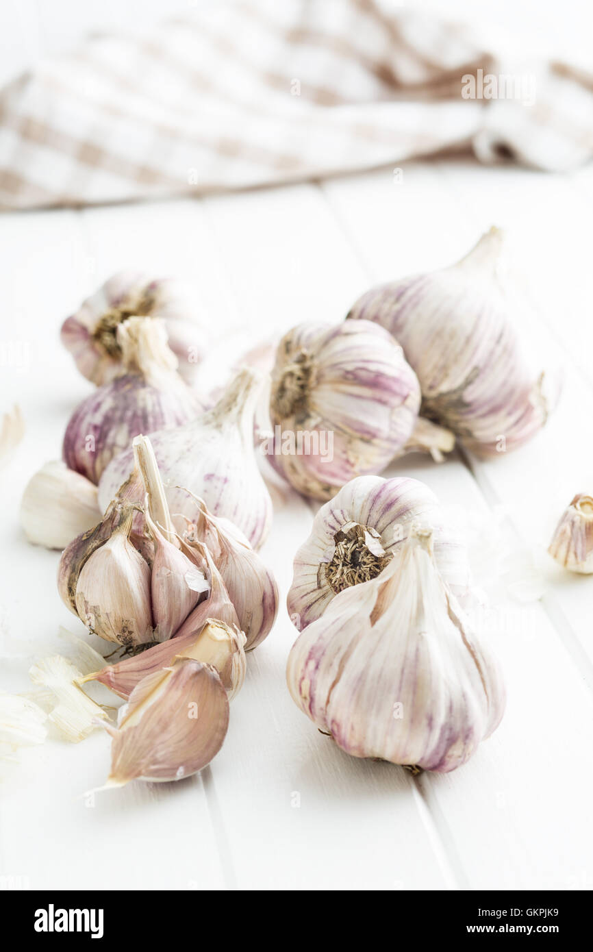 The fresh garlic on kitchen table. Stock Photo