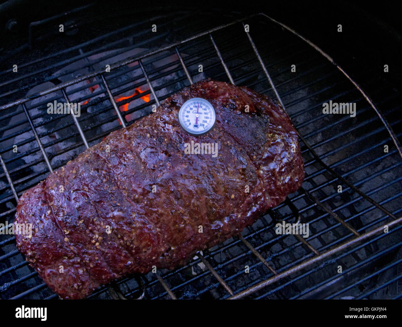 Beef roast(Joint) on Charcoal bbq , with thermometer Stock Photo