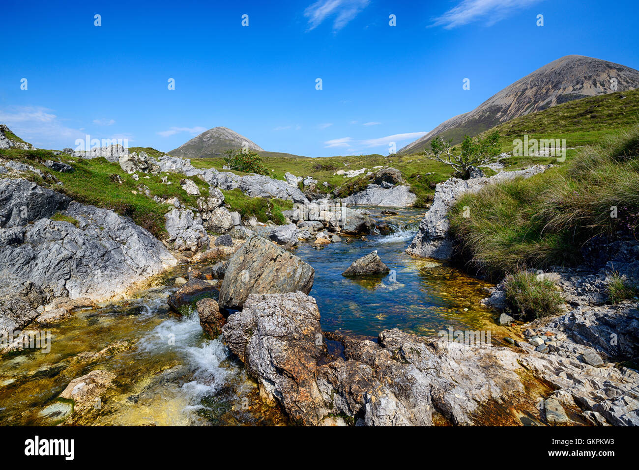 The Allt Aisridh tumbles over rocks and cascades on its way in to Loch Saplin at Torrin on the Isle of Skye in Scotland Stock Photo