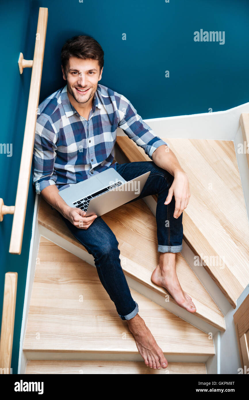 Young guy sitting home barefoot hi-res stock photography and images - Alamy