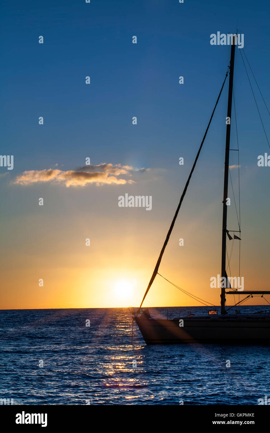 Sailing Yacht in the sea at sunset Stock Photo - Alamy